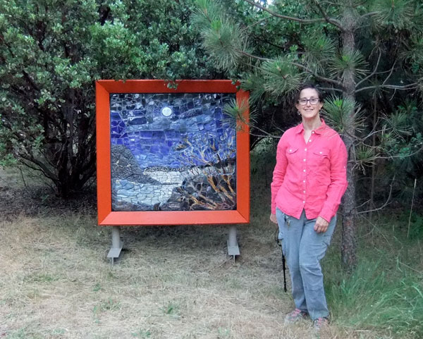 Artist Alicia Lee Farnsworth next  to her Handmade Mosaic Landscape paying homage to the full moon over Clear Lake in Lake County California for 2013's EcoArts Sculpture Walk
