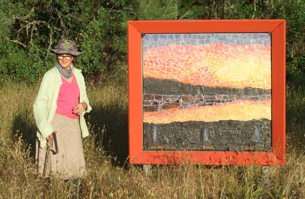 Intallation picture of Artist, Alicia Lee Farnsworth and her 4'x4' hand made, custom glazed and grouted landscape mosaic called "Clearlake Winter Sunset' installed at the Middletown County Trailside park as part of Ecoartarts of Lake County Sculpture Walk 2015. from June-October